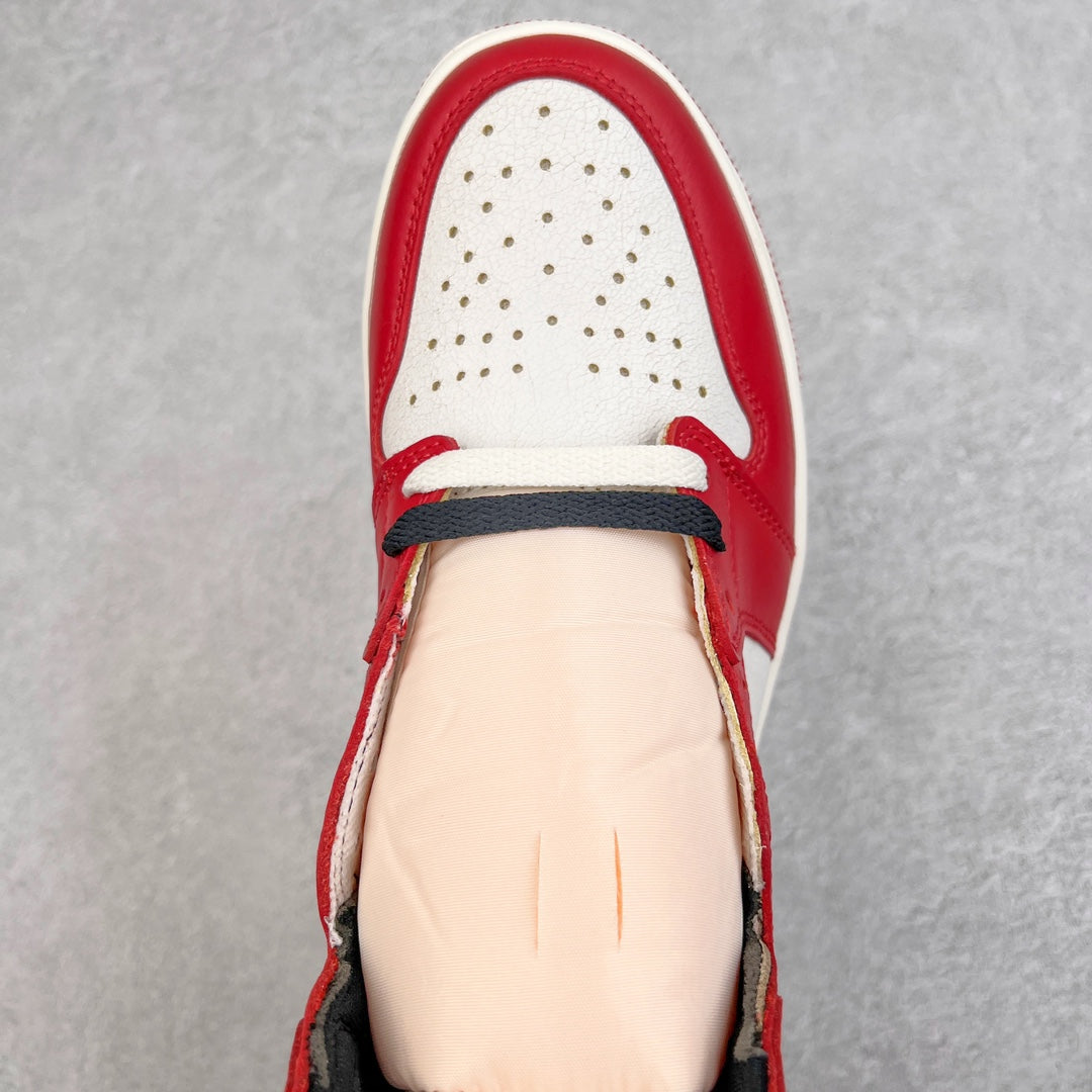 High-top sneaker toe and lace area with red leather and white perforated panels