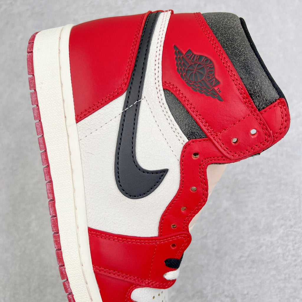 High-top sneaker side view with red leather, black swoosh, and white overlays
