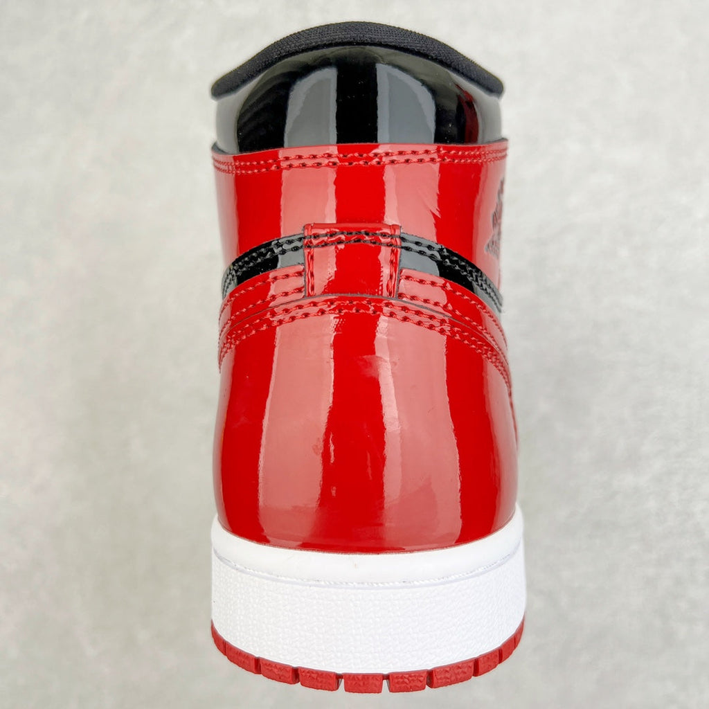 High-top sneaker heel in glossy red with black back strap and white sole.