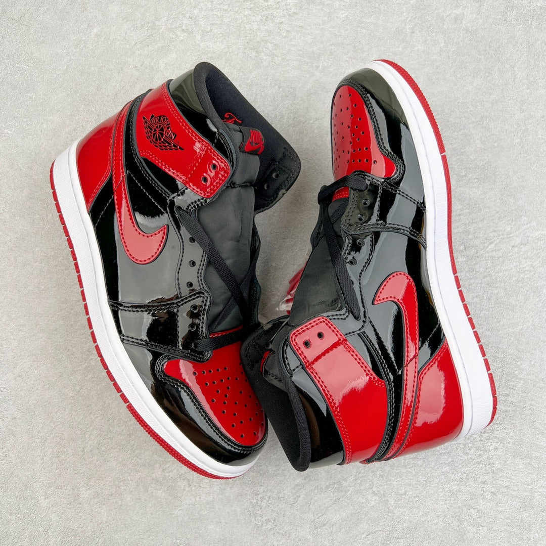 High-top sneaker in black and red patent with white midsole and stitched overlays.