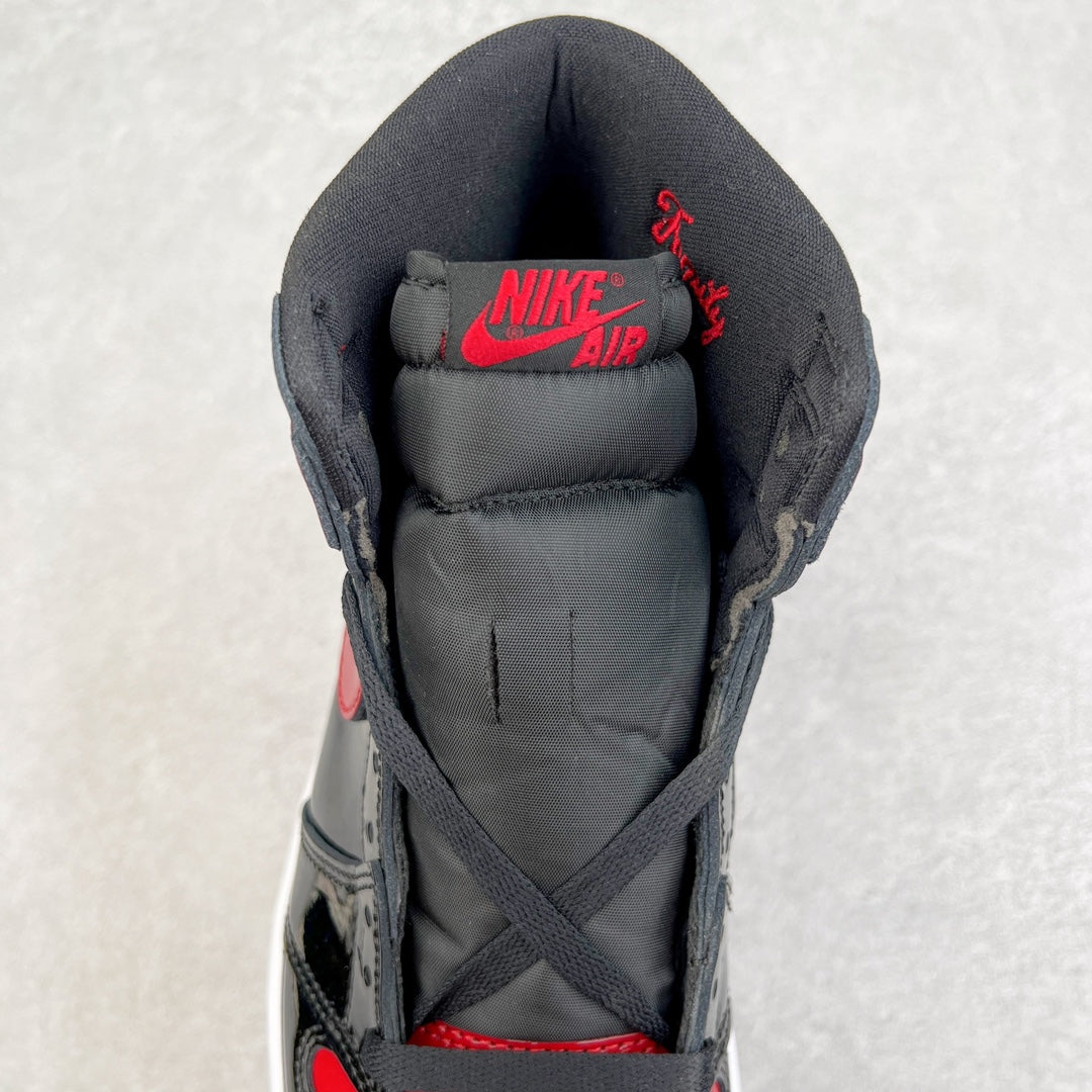 High-top sneaker tongue with red Nike Air text, black padded collar, lace-up.
