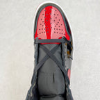 High-top sneaker toe box view: red perforated panel, black laces, dark lining.