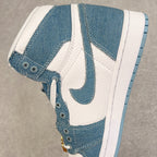 Denim blue and white high-top sneakers with swoosh, denim overlays, gold chain charm