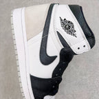 High-top sneakers with white leather upper, black Swoosh, and Wings logo on the collar
