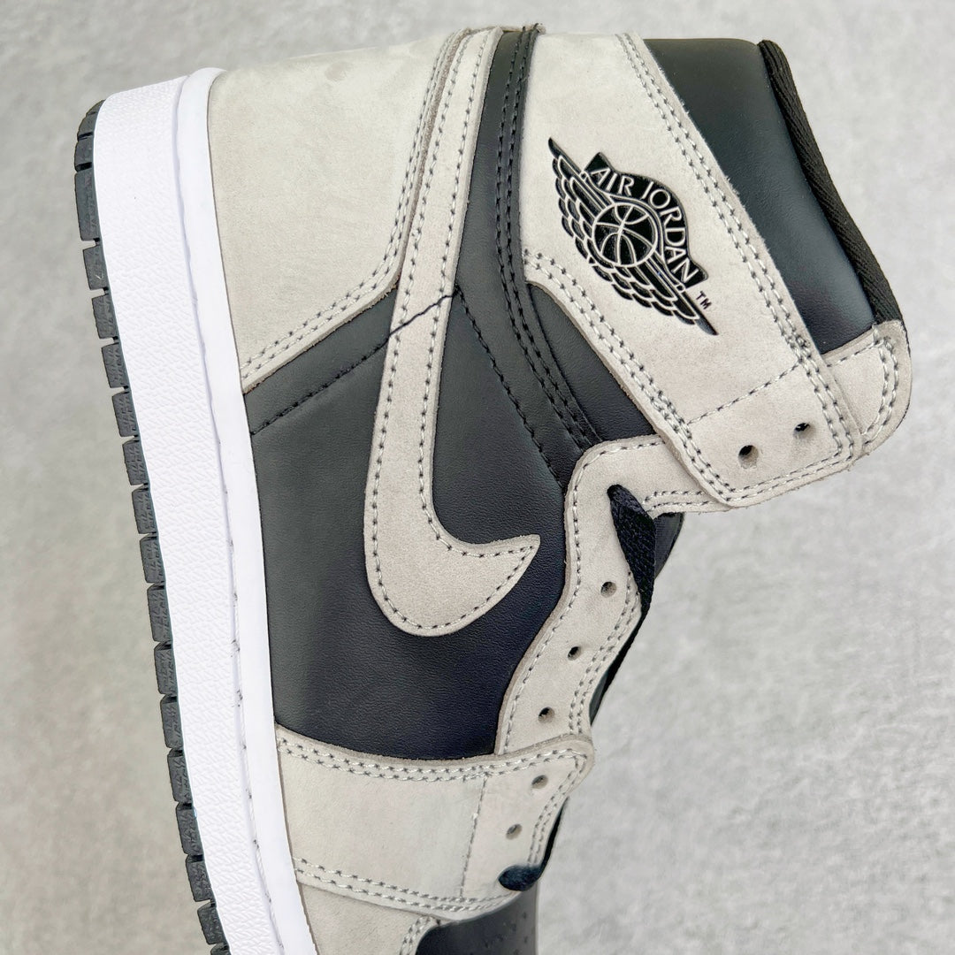 High-top sneakers with cream upper, navy swoosh, and Air Jordan wing logo on ankle.