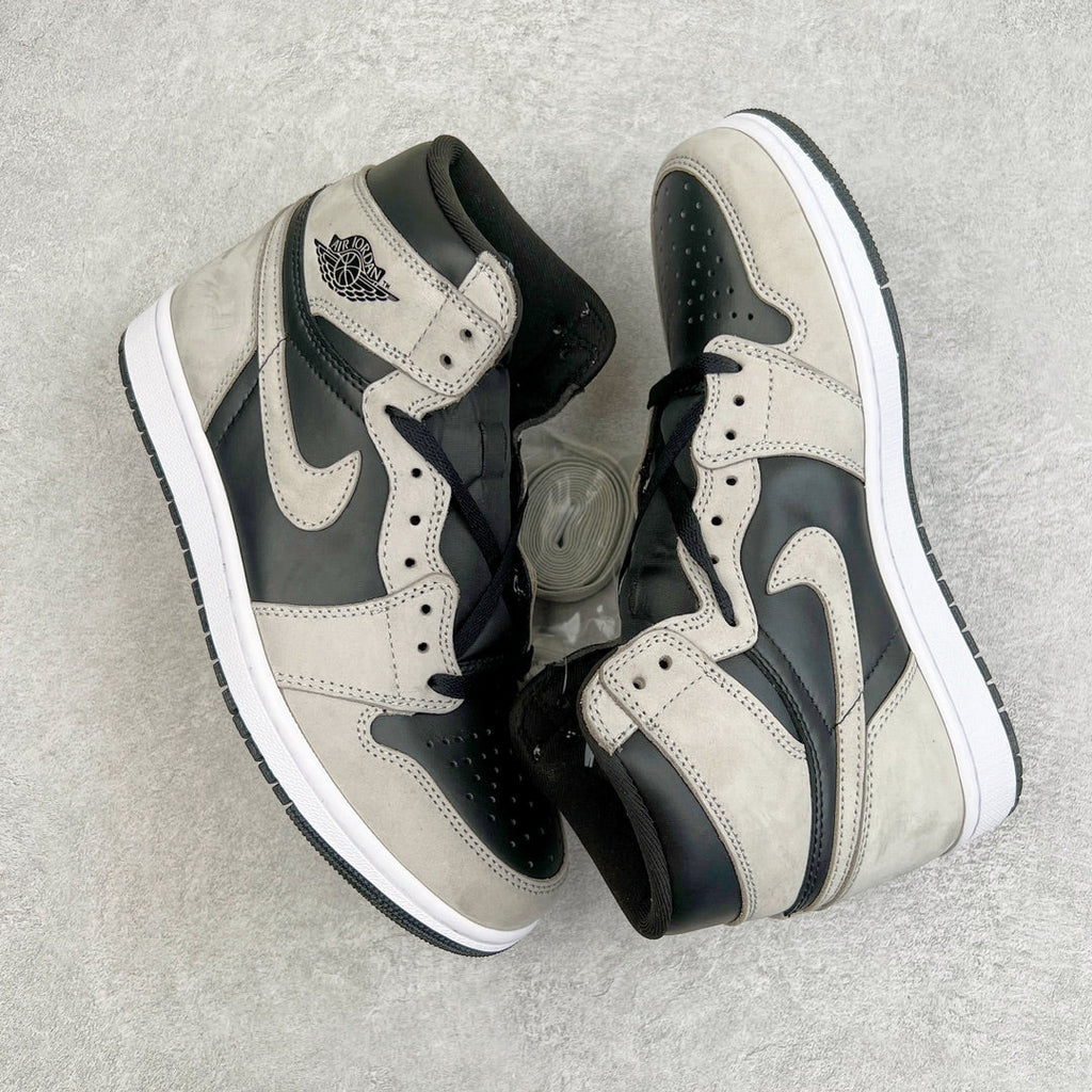 High-top sneakers with cream leather, black overlays, and Nike swoosh on the side.