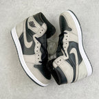 High-top sneakers with cream leather, black overlays, and Nike swoosh on the side.