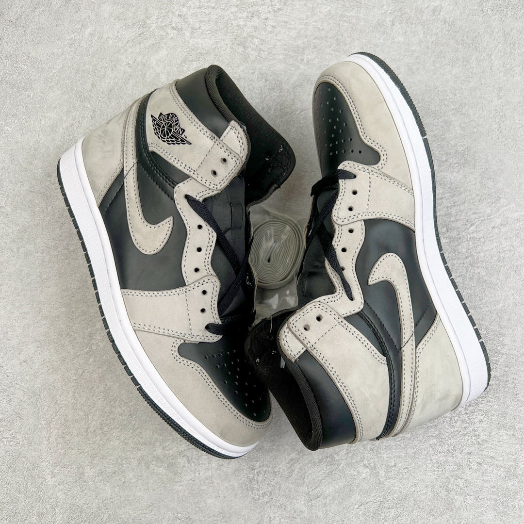 High-top sneakers with cream leather, black overlays, and Nike swoosh on the side.