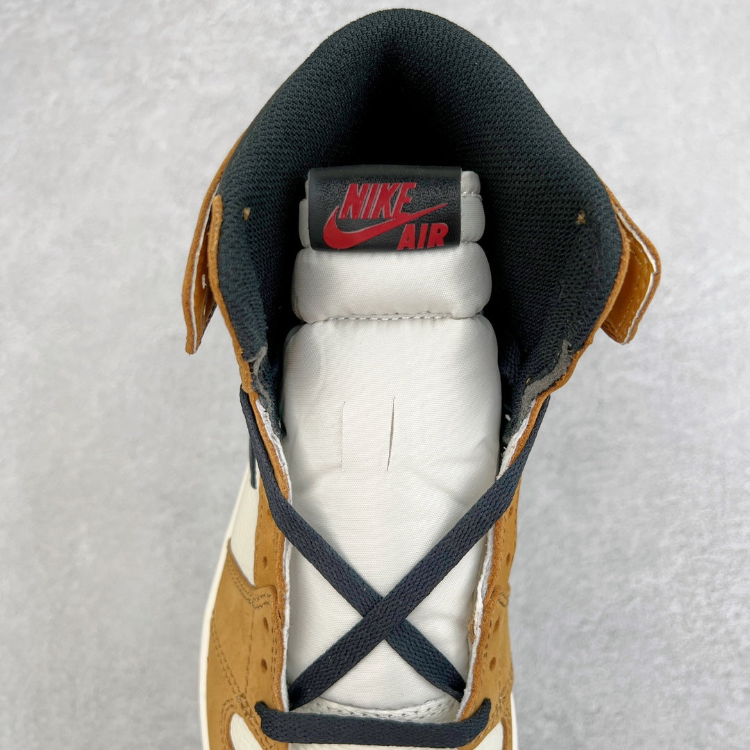 High-top sneaker tongue and heel with Nike Air label, navy laces, tan suede, black collar.
