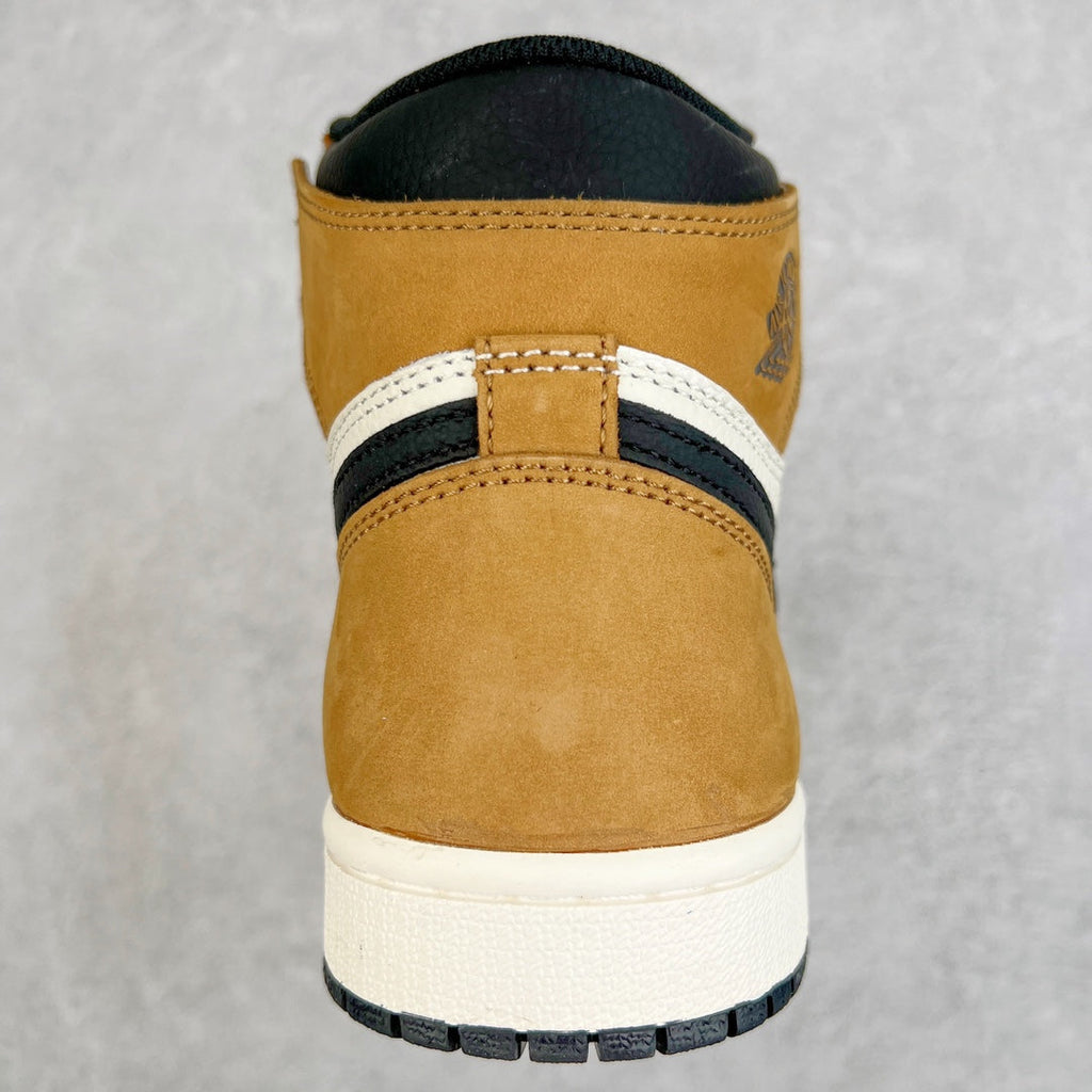High-top sneaker heel in tan suede with black collar and white midsole edge.