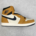High-top sneakers with tan suede panels, white side panels, and navy swoosh accents.