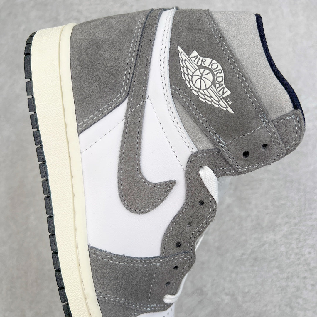 High-top sneaker side view with gray suede, white paneling, and Jordan logo near ankle.