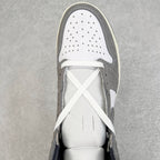 High-top sneaker toe with perforations, white laces, white and smoke gray panels.