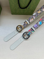 Gucci belt set with light gray straps, multicolor cartoon print, and round logo buckles