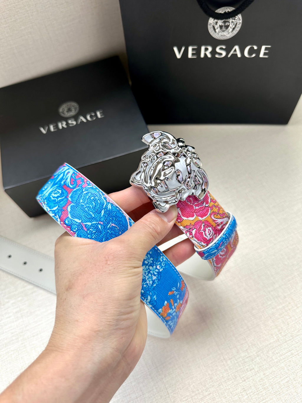 Versace belt with bright blue and pink floral strap and silver lion buckle
