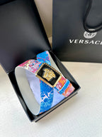 Versace belt detail: patterned pink and blue strap with gold Medusa buckle in box