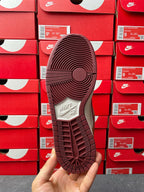 Nike Dunk Low sneaker outsole view in dark burgundy with traction grooves