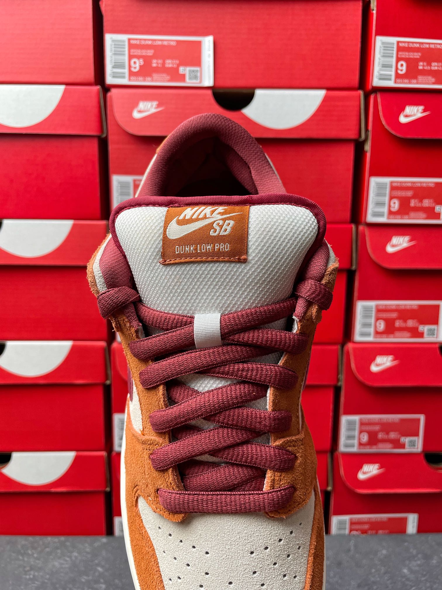 Nike Dunk Low sneaker heel view with burgundy lining and padded collar, tan and cream panels