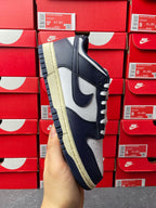 Midnight navy and white low-top sneakers on side view, cream gum-style outsole