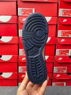 Navy low-top sneaker outsole view with tread pattern and Nike mark