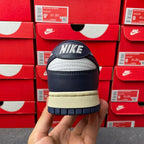 Midnight navy and white sneakers heel view with Nike logo and cream rubber outsole