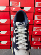 Midnight navy and white low-top sneakers with white laces and Nike logo on tongue