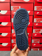 Low-top sneaker outsole in navy with textured traction pattern and circular tread.