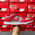 Low-top sneaker with red upper, gray Swoosh, white midsole, and red outsole.