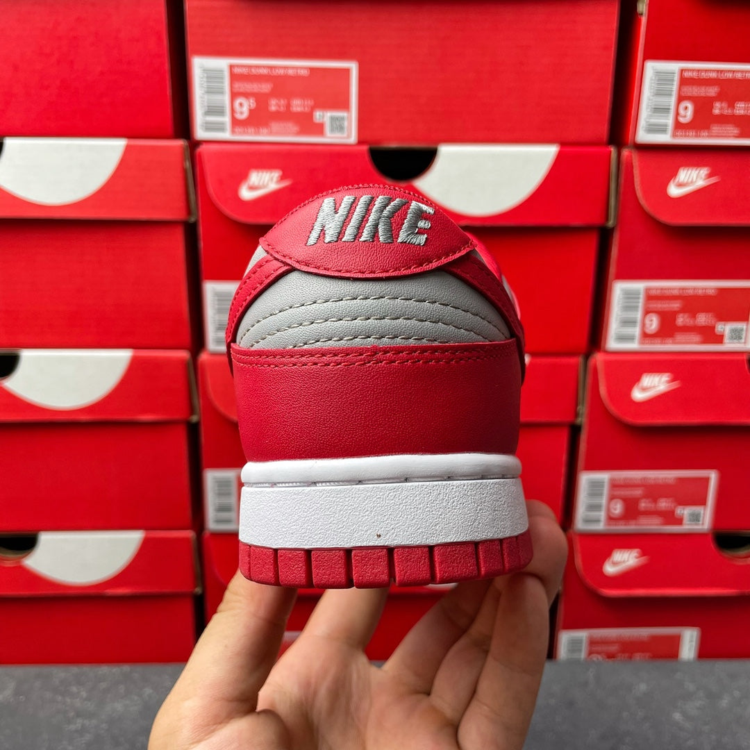 Low-top sneaker heel view with red leather back, gray toe box, and white outsole.