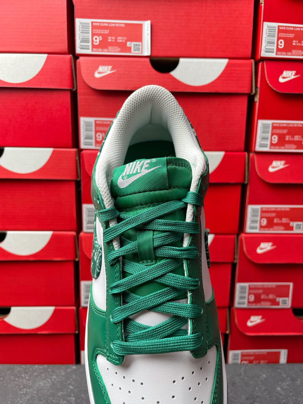 Nike Dunk Low sneaker showing green tongue with white logo and green laces