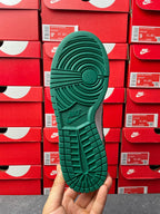 Nike Dunk Low outsole view in green with grid tread and circular traction pattern