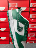 Nike Dunk Low shoe with green leather panels, white midsole, and green lace eyelets