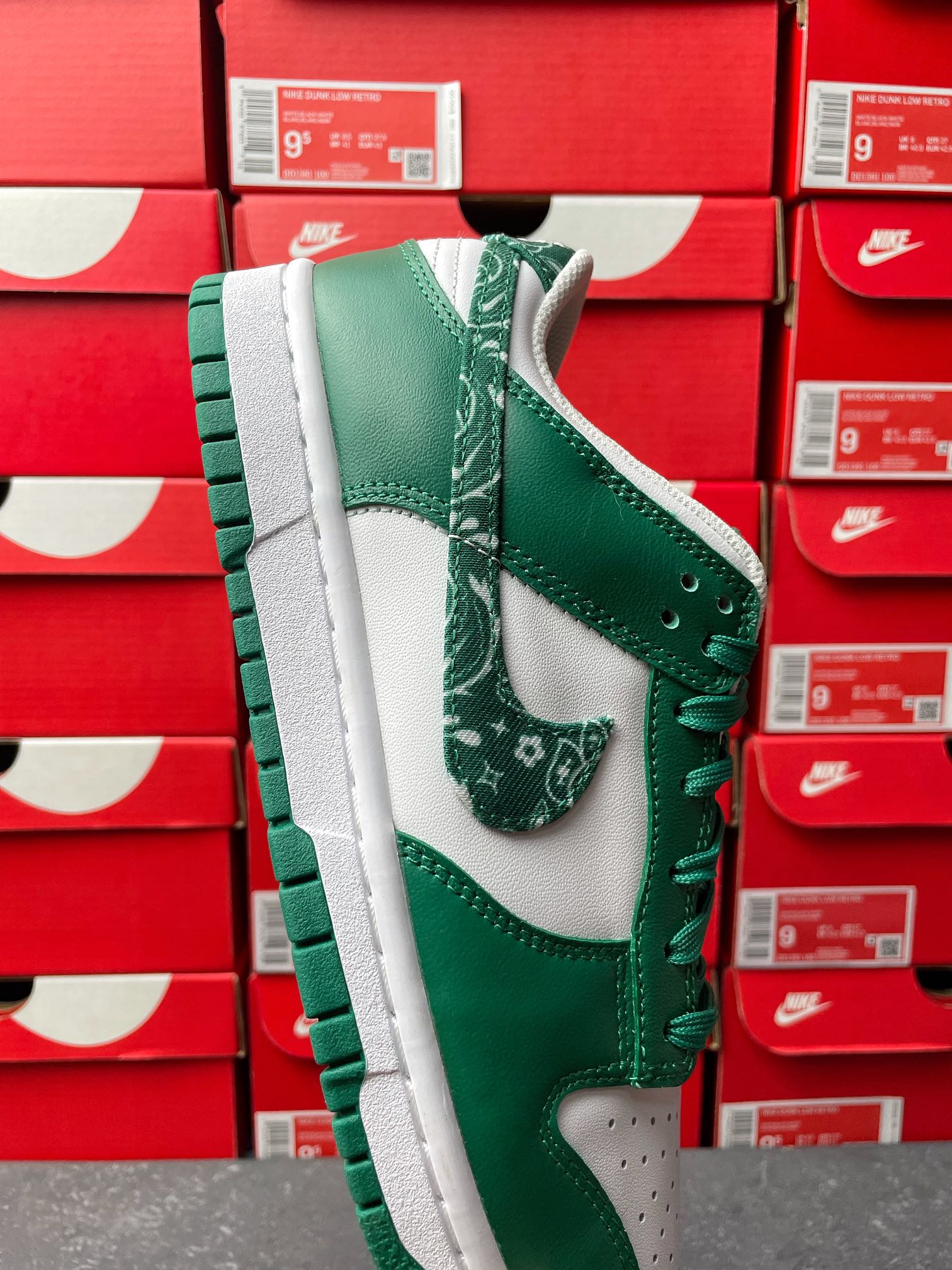 Nike Dunk Low shoe with green leather panels, white midsole, and green lace eyelets