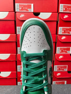 Nike Dunk Low top view with green collar, white perforated toe, and green laces