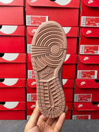 Brown low-top sneaker outsole with traction tread and Nike logo