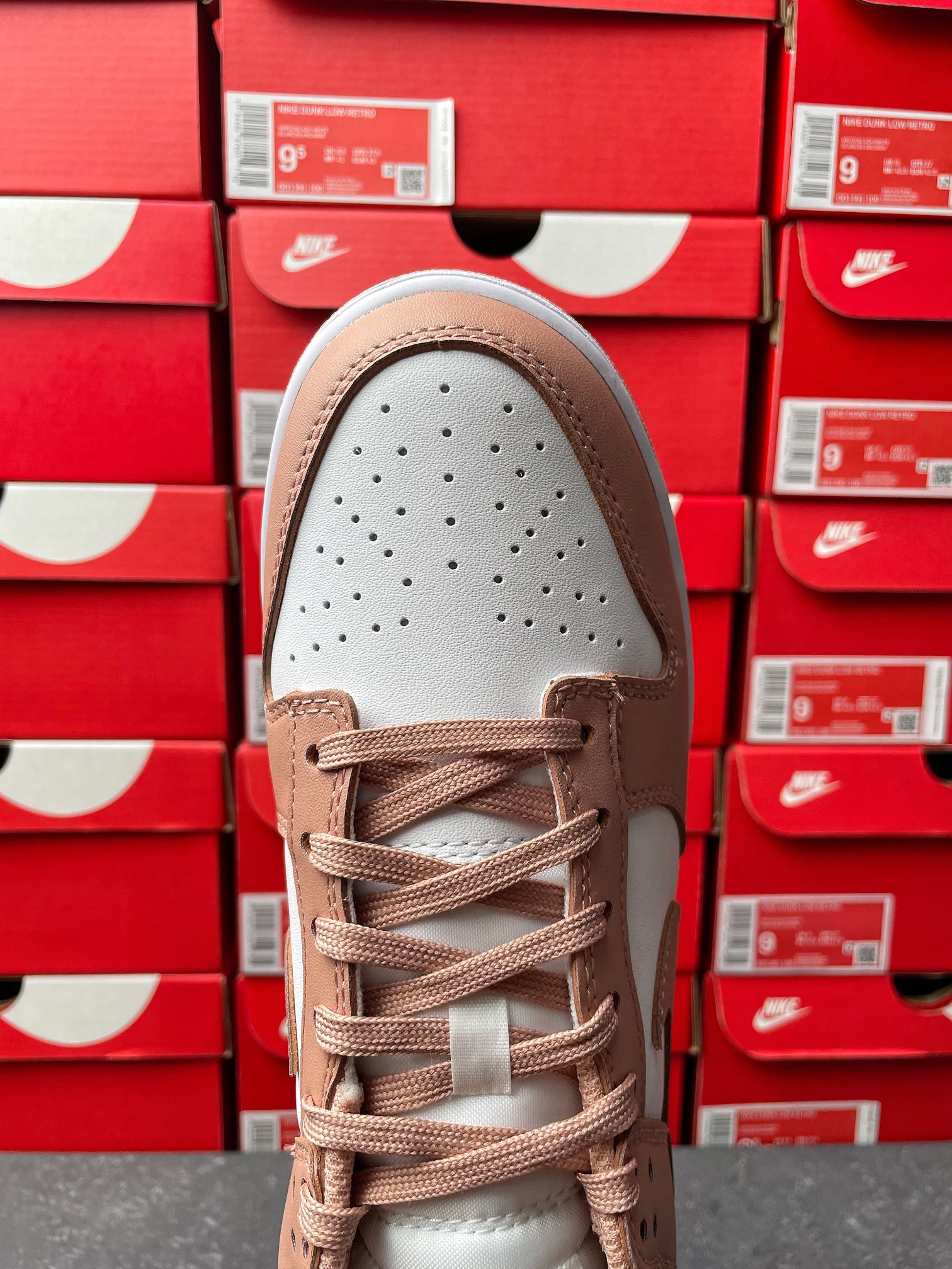 Brown and white low-top sneaker, toe box view with perforations