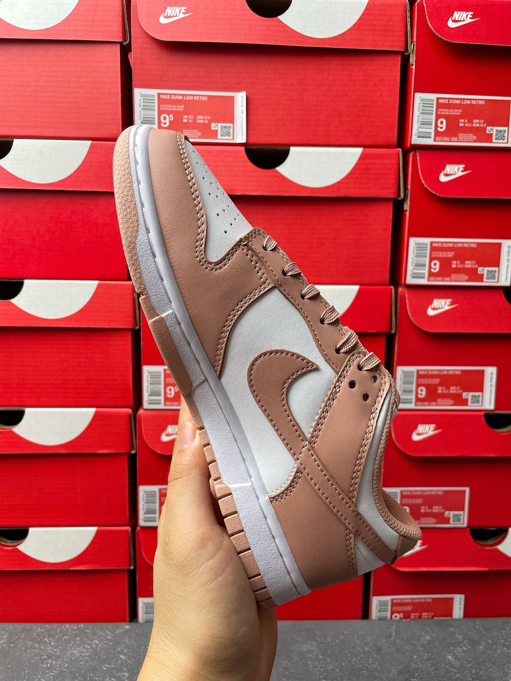Brown and white low-top sneaker, angled side view with lace-up and swoosh