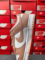 Brown and white low-top sneaker, side profile with stitched overlays