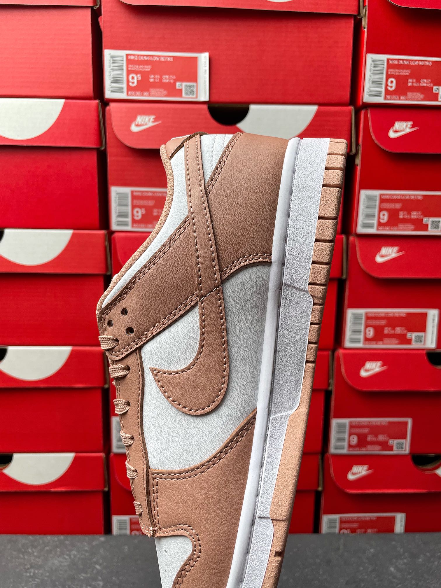 Brown and white low-top sneaker, side profile with stitched overlays