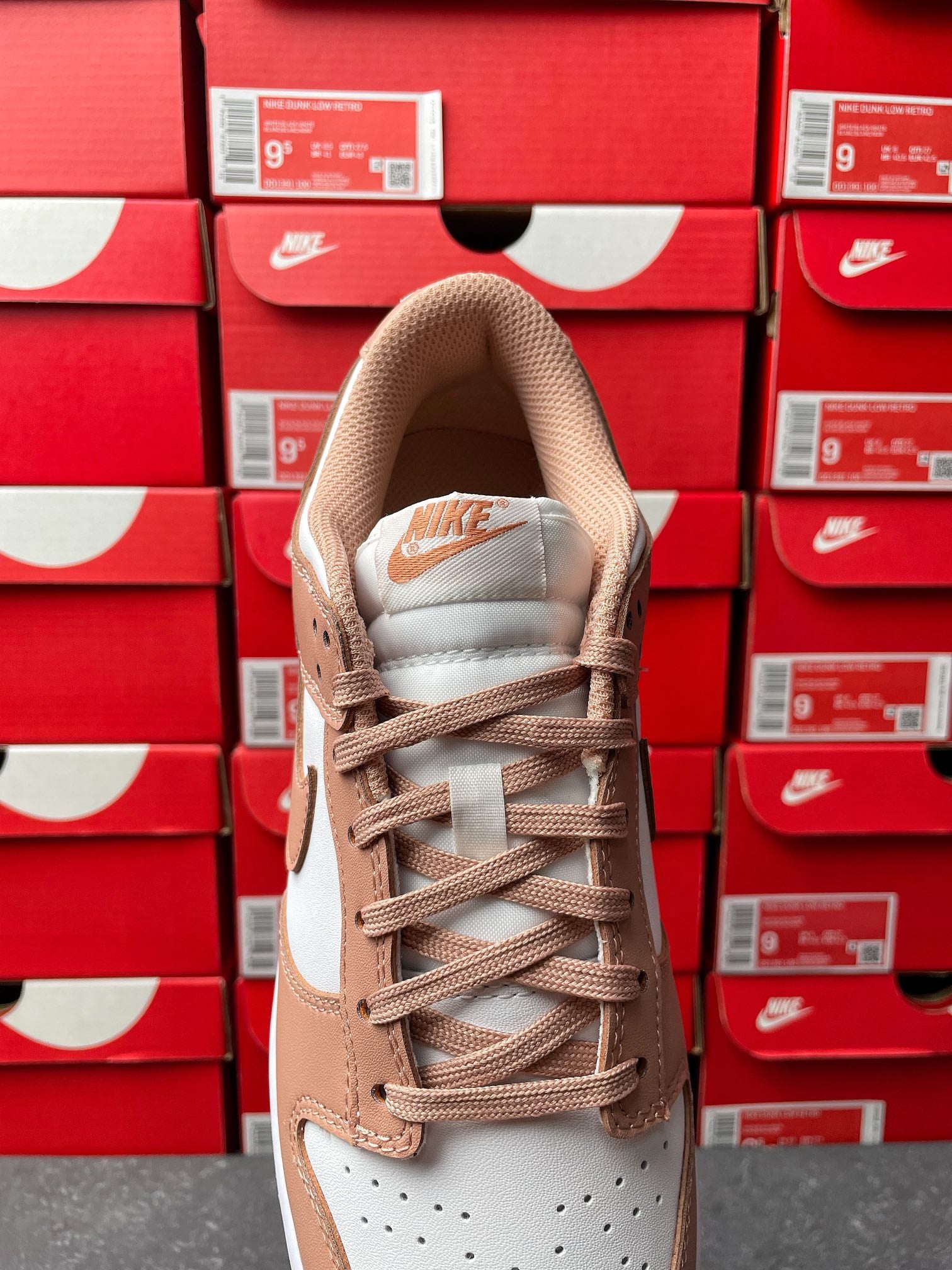 Brown and white low-top sneakers with lace-up front and padded collar