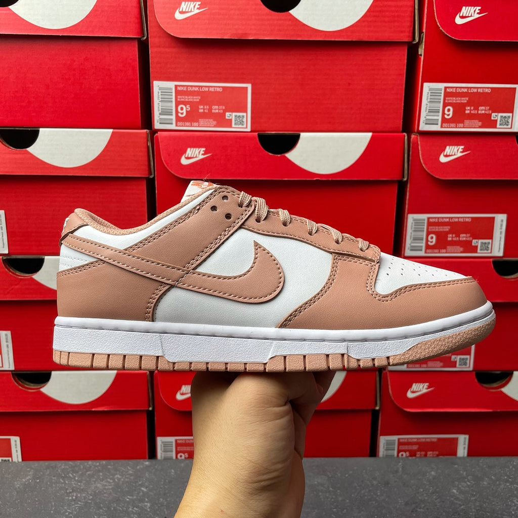 Brown and white low-top sneakers with Nike swoosh and tan lace-up panels