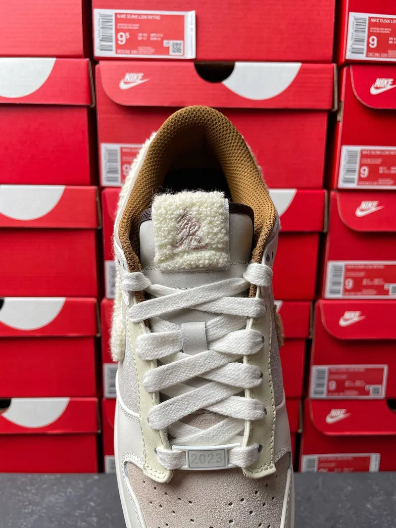 Nike Dunk Low low-top sneaker tongue and collar, light gray with plush tan lining