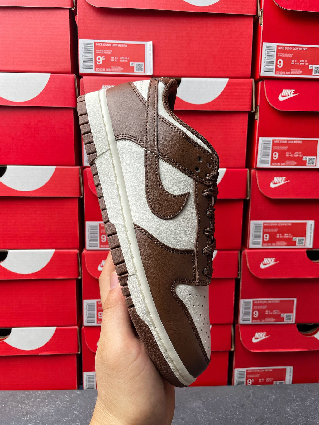 Brown and white low-top sneaker with lace-up front and off-white sole