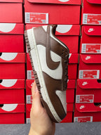 Brown and white low-top sneaker with lace-up front and off-white sole