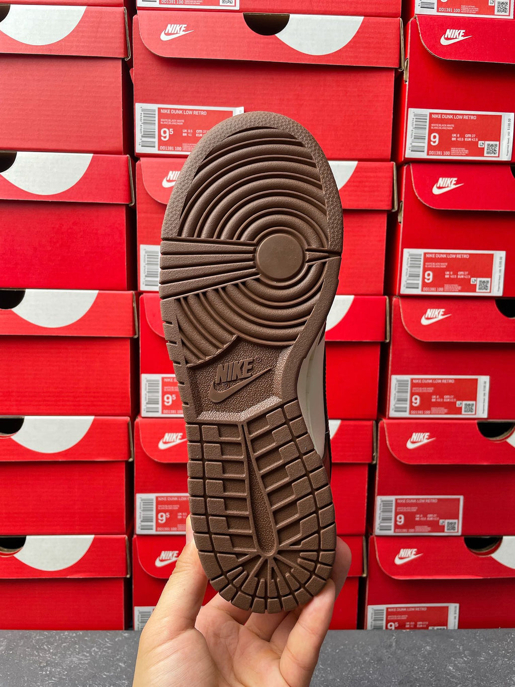 Low-top sneaker outsole view with tread pattern and Nike logo