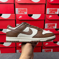 Brown and white low-top sneaker with suede overlays and white side panel