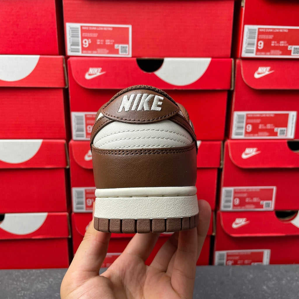 Low-top sneaker heel view with Nike logo and off-white midsole