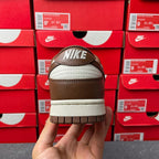 Low-top sneaker heel view with Nike logo and off-white midsole