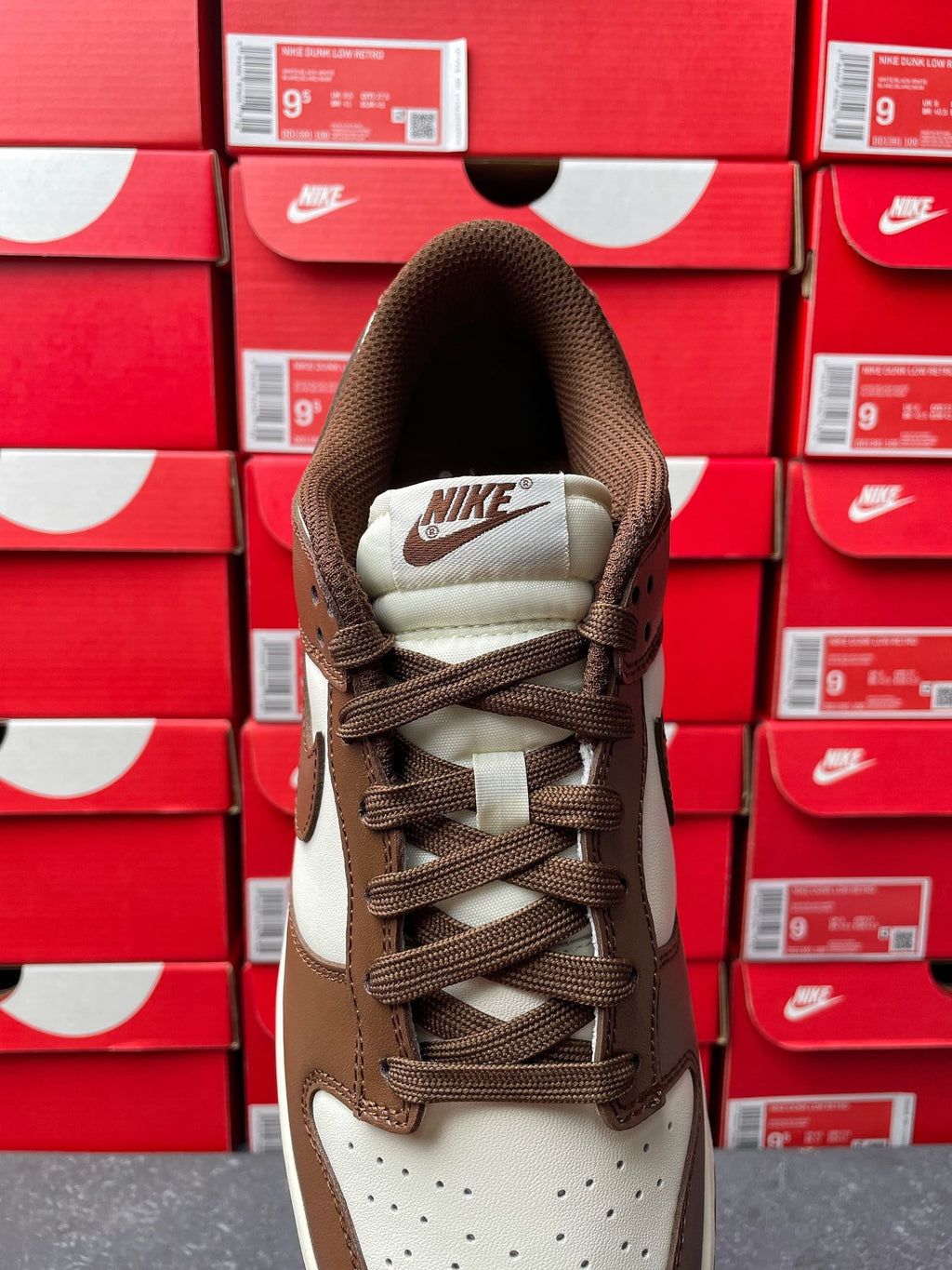 Brown low-top sneaker with Nike heel tab, lace-up front, off-white midsole
