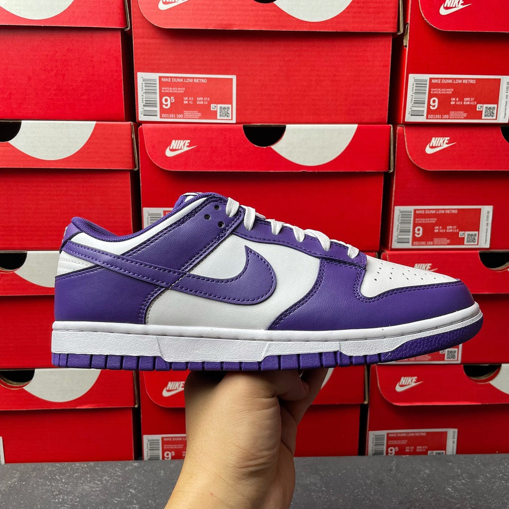 Nike Dunk Low sneaker in purple and white, lace-up with Nike swoosh on side